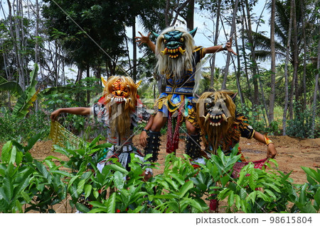 devil mask dancer pose, original from Indonesia with tree background devil mask dancer pose, original from Indonesia with tree background 98615804