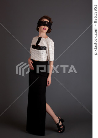 beautiful girl in a black skirt with a bandage on eyes, model posing on a black background vintage beautiful girl in a black skirt with a bandage on eyes, model posing on a black background vintage 98615953
