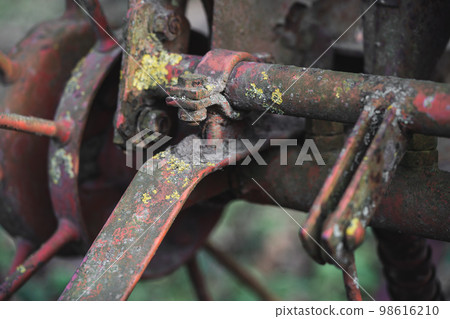 old rusty metal spare parts for work in agriculture 98616210