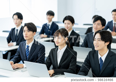 Business seminar Young business man and business woman in suits 98616466