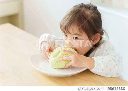 girl eating melon bread girl eating melon bread 98616888