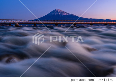 Shinkansen and Mt.Fuji passing Fujikawa iron bridge early in the morning 98617170