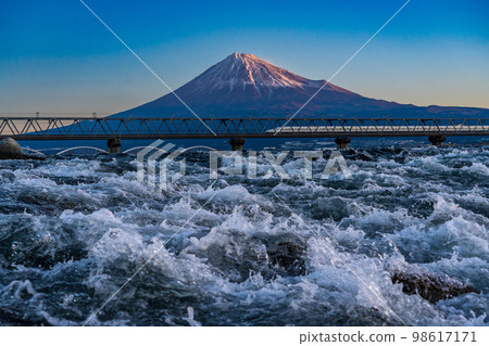 Shinkansen and Mt. Fuji passing through the torrent Fuji River 98617171
