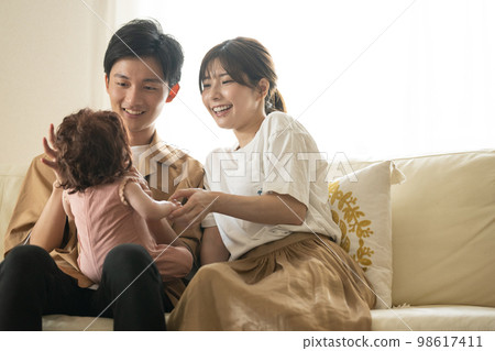 A couple taking care of a baby, raising a young couple A couple taking care of a baby, raising a young couple 98617411