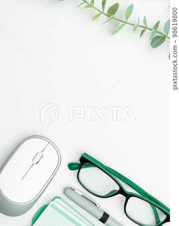 Office Supplies Over Desk With Keyboard And Glasses And Coffee Cup For Working Remotely, Assorted School Utilities For Studying With Hot Drink And Eyeglasses. 98619800