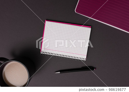 Coffee Cup Standing on Desk. Important infrormation written on paper. Different Office Supplies, Pencils, Pens, Marckers. Computer keyboard. Text on wood table. Coffee Cup Standing on Desk. Important infrormation written on paper. Different Office Supplies, Pencils, Pens, Marckers. Computer keyboard. Text on wood table. 98619877