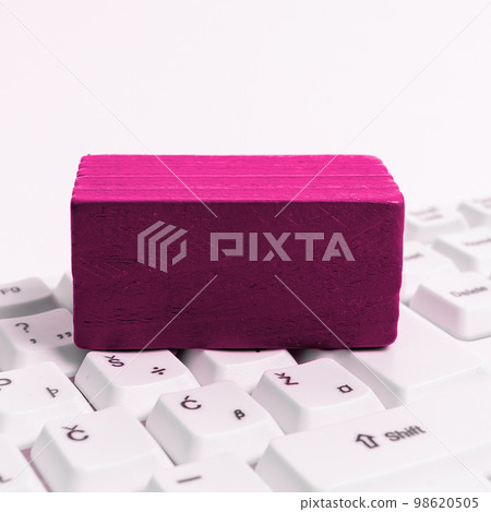 Colored wood cube with important message lying near keyboard. Main information written on notebook. School supplies. Multiple Assorted Collection Office Stationery. 98620505