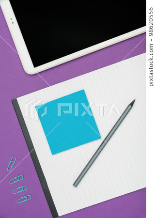 Mobile Phone Lying on Desk. Important infrormation written on colored paper and notebook. Different Office Supplies, Pencils, Pens, Marckers. Computer keyboard. Mobile Phone Lying on Desk. Important infrormation written on colored paper and notebook. Different Office Supplies, Pencils, Pens, Marckers. Computer keyboard. 98620556