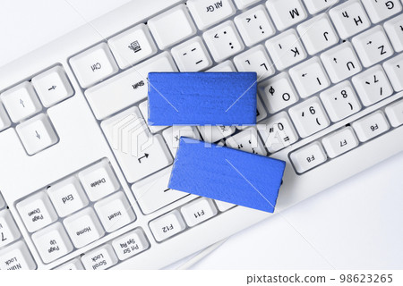 Colored wood cube with important message lying near keyboard. Main information written on notebook. School supplies. Multiple Assorted Collection Office Stationery. 98623265
