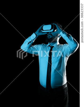 Man Wearing Vr Glasses And Looking On Important Messages. Businessman Having Virtual Reality Eyeglasses And Showing Crutial Informations. 98623337