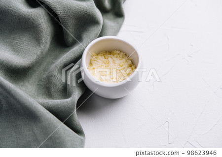 Grated aged italian parmesan cheese in white bowl Grated aged italian parmesan cheese in white bowl 98623946