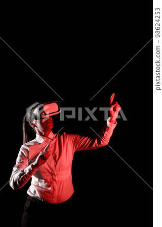 Woman Wearing Vr Glasses And Pointing On Important Messages With One Finger. Businesswoman Having Virtual Reality Eyeglasses And Showing Crutial Informations. Woman Wearing Vr Glasses And Pointing On Important Messages With One Finger. Businesswoman Having Virtual Reality Eyeglasses And Showing Crutial Informations. 98624253