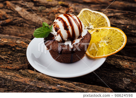Chocolate fondant cake, molten lava cake with lemon slices Chocolate fondant cake, molten lava cake with lemon slices 98624598