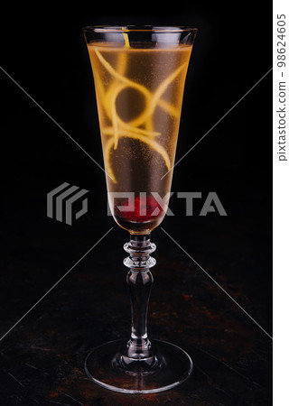 Elegant glass of yellow champagne with raspberry 98624605