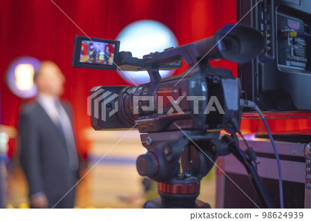 cameraman filming an interview cameraman filming an interview 98624939