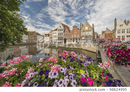 Bruges Belgium, city skyline at Spiegelrei Canal with summer flower 98624995