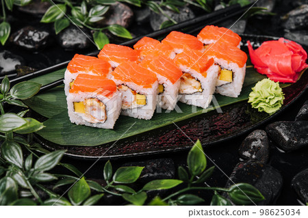 Set of salmon sushi rolls on stone plate 98625034