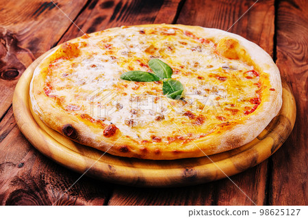Pizza Margarita on a wooden background 98625127
