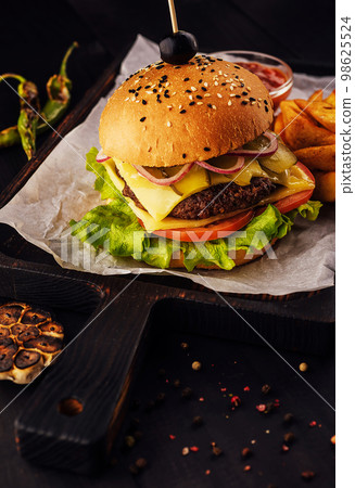 Fresh juicy burger on a cutting board Fresh juicy burger on a cutting board 98625524