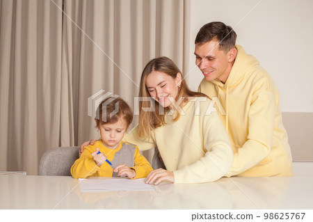 Happy smiling family, parents, mom and dad with son painting Happy smiling family, parents, mom and dad with son painting 98625767