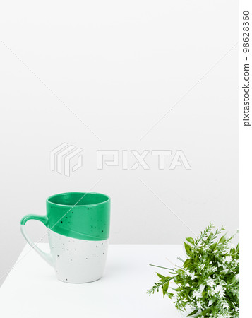 Coffee Cup Standing on Desk. Important infrormation written on paper. Different Office Supplies, Pencils, Pens, Marckers. Computer keyboard. Text on wood table. 98628360