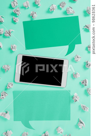 Important Message Presented On Phone On Desk With Paperwraps, Paper. Crutial Information Shown On Cellphone Screen Placed On Table. New Ideas On Mobile Phone. 98628361