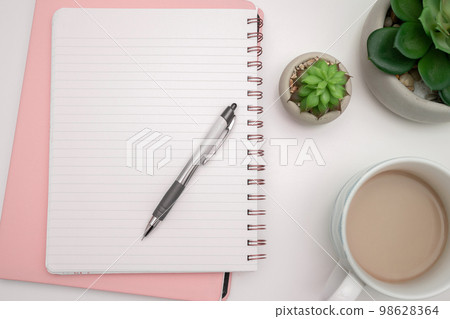 Coffee Cup Standing on Desk. Important infrormation written on paper. Different Office Supplies, Pencils, Pens, Marckers. Computer keyboard. Text on wood table. 98628364