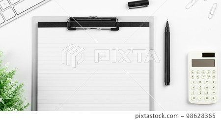 Colored paper with important message lying desk near keyboard. Main information written on notebook. School supplies. Multiple Assorted Collection Office Stationery. Colored paper with important message lying desk near keyboard. Main information written on notebook. School supplies. Multiple Assorted Collection Office Stationery. 98628365