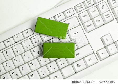 Colored wood cube with important message lying near keyboard. Main information written on notebook. School supplies. Multiple Assorted Collection Office Stationery. 98628369