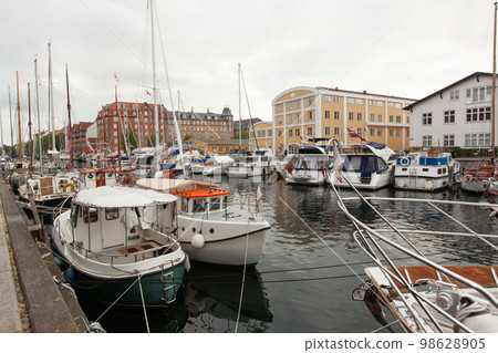 beautiful harbor with many boats in the canal between the houses. beautiful harbor with many boats in the canal between the houses. 98628905