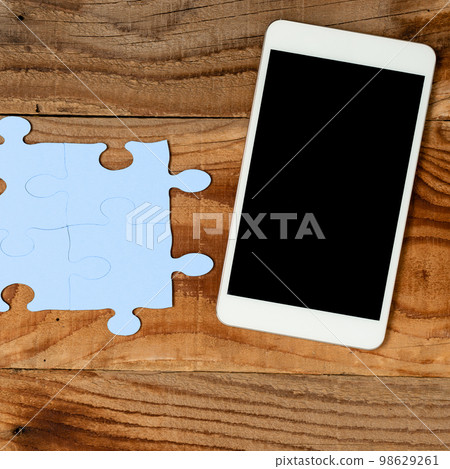 Mobile Phone With Important Message On Desk With Empty Blue Puzzels And Notes. Cellphone Screen With Crutial Informations On Table With Notepad And Memos. Mobile Phone With Important Message On Desk With Empty Blue Puzzels And Notes. Cellphone Screen With Crutial Informations On Table With Notepad And Memos. 98629261