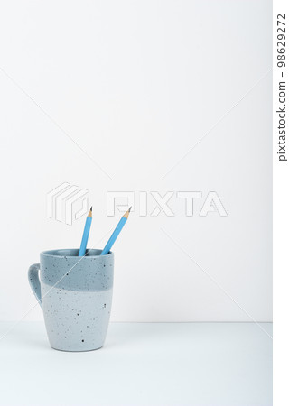 Coffee Cup Standing on Desk. Important infrormation written on paper. Different Office Supplies, Pencils, Pens, Marckers. Computer keyboard. Text on wood table. Coffee Cup Standing on Desk. Important infrormation written on paper. Different Office Supplies, Pencils, Pens, Marckers. Computer keyboard. Text on wood table. 98629272