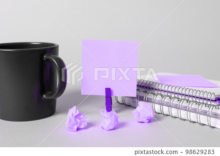 Coffee Cup Standing on Desk. Important infrormation written on paper. Different Office Supplies, Pencils, Pens, Marckers. Computer keyboard. Text on wood table. Coffee Cup Standing on Desk. Important infrormation written on paper. Different Office Supplies, Pencils, Pens, Marckers. Computer keyboard. Text on wood table. 98629283