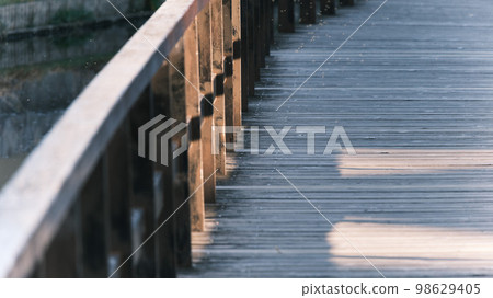 Evening bridge over a pond in Japan 98629405
