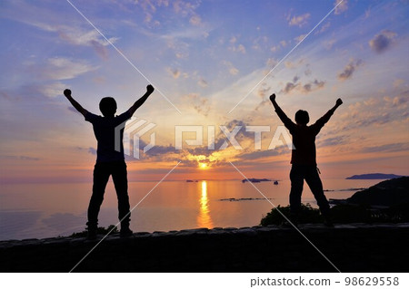 Shadows of people watching the sunset from Sotome Roadside Station Yuhigaoka Shadows of people watching the sunset from Sotome Roadside Station Yuhigaoka 98629558