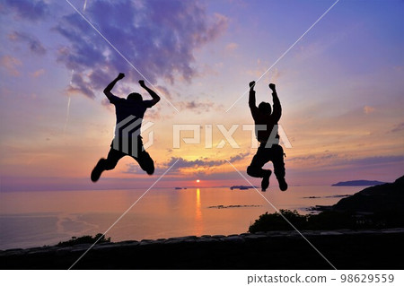 People jumping while watching the sunset at Roadside Station Yuhigaoka Sotome 98629559
