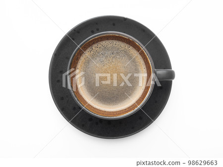 Large black coffee in porcelain cup with saucer on white. Top view. 98629663