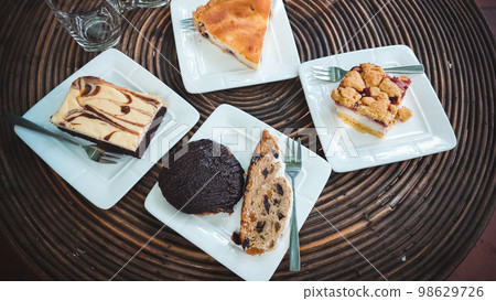 Traditional german Christmas stollen cake or Christstollen and other cakes at a cafe Traditional german Christmas stollen cake or Christstollen and other cakes at a cafe 98629726