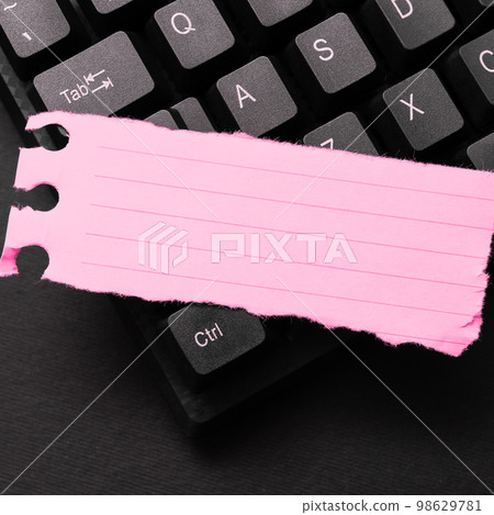 Colored sticker lying on black keyboard. Important information written over paper. Image with school supplies. Multiple Assorted Collection Office Stationery. 98629781