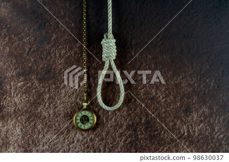 Vintage Pocket Watch and Hangmans Noose on a Mottled Background Vintage Pocket Watch and Hangmans Noose on a Mottled Background 98630037