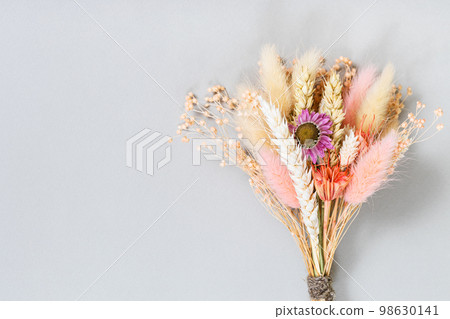tied bouquet of dried flower and spikelets on gray 98630141