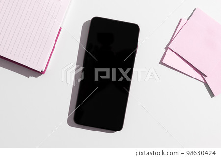 Mobile Phone Screen With Important Ideas On It And Note Sticked On It On Desk With Notebook And Marker. Cellphone With Crutial Informations And Memo Attached To It. Mobile Phone Screen With Important Ideas On It And Note Sticked On It On Desk With Notebook And Marker. Cellphone With Crutial Informations And Memo Attached To It. 98630424