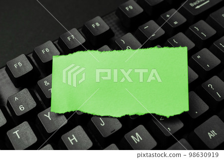 Colored sticker lying on black keyboard. Important information written over paper. Image with school supplies. Multiple Assorted Collection Office Stationery. Colored sticker lying on black keyboard. Important information written over paper. Image with school supplies. Multiple Assorted Collection Office Stationery. 98630919