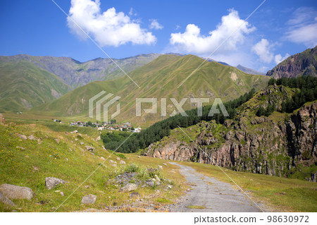Colorful landscape with high mountains, beautiful winding road, green forest. Mountain valley. Travel in Georgia 98630972