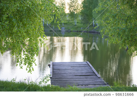 Beautiful natural background. Lake trees and wooden bridge. 98631666