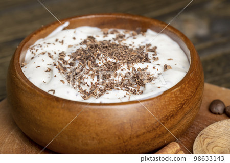Yogurt made from cream with the addition of chocolate pieces and crumbs 98633143