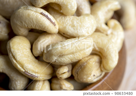 fresh cashew nuts on the table fresh cashew nuts on the table 98633480