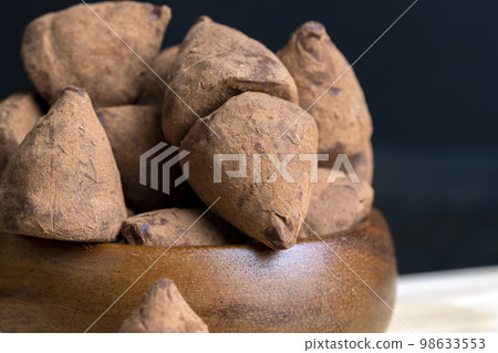 Chocolate truffle candy on the board 98633553
