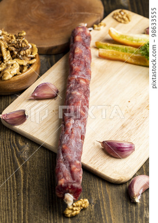 Sausage cut into pieces on the table Sausage cut into pieces on the table 98633555