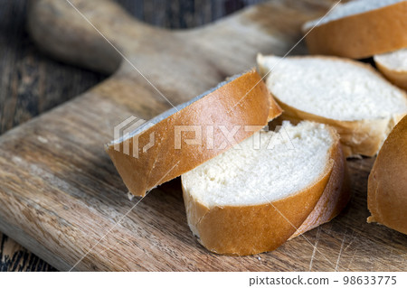 Sliced wheat loaf on the table 98633775
